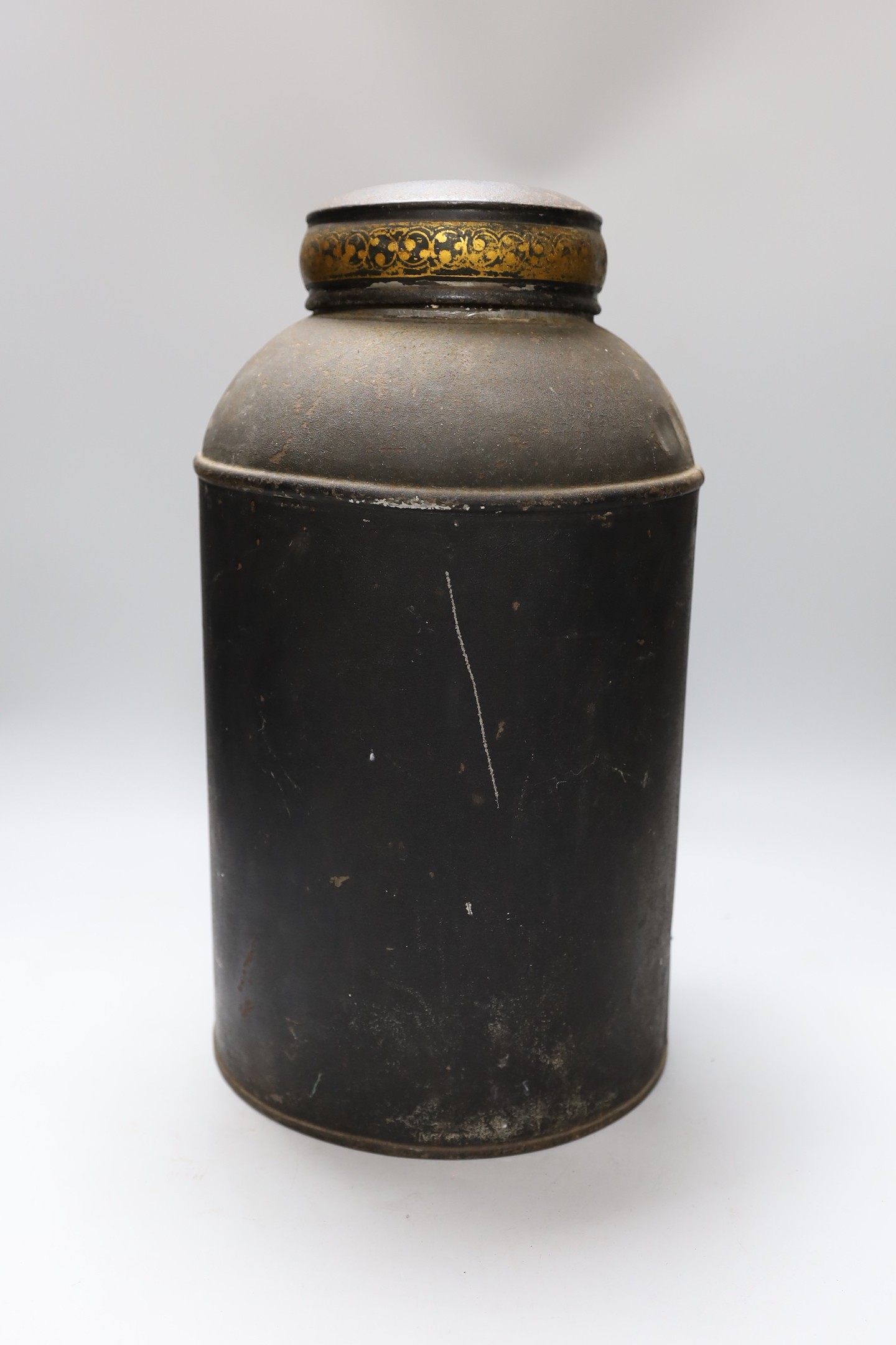A Chinoiserie decorated toleware tea cannister and cover, 42cms high